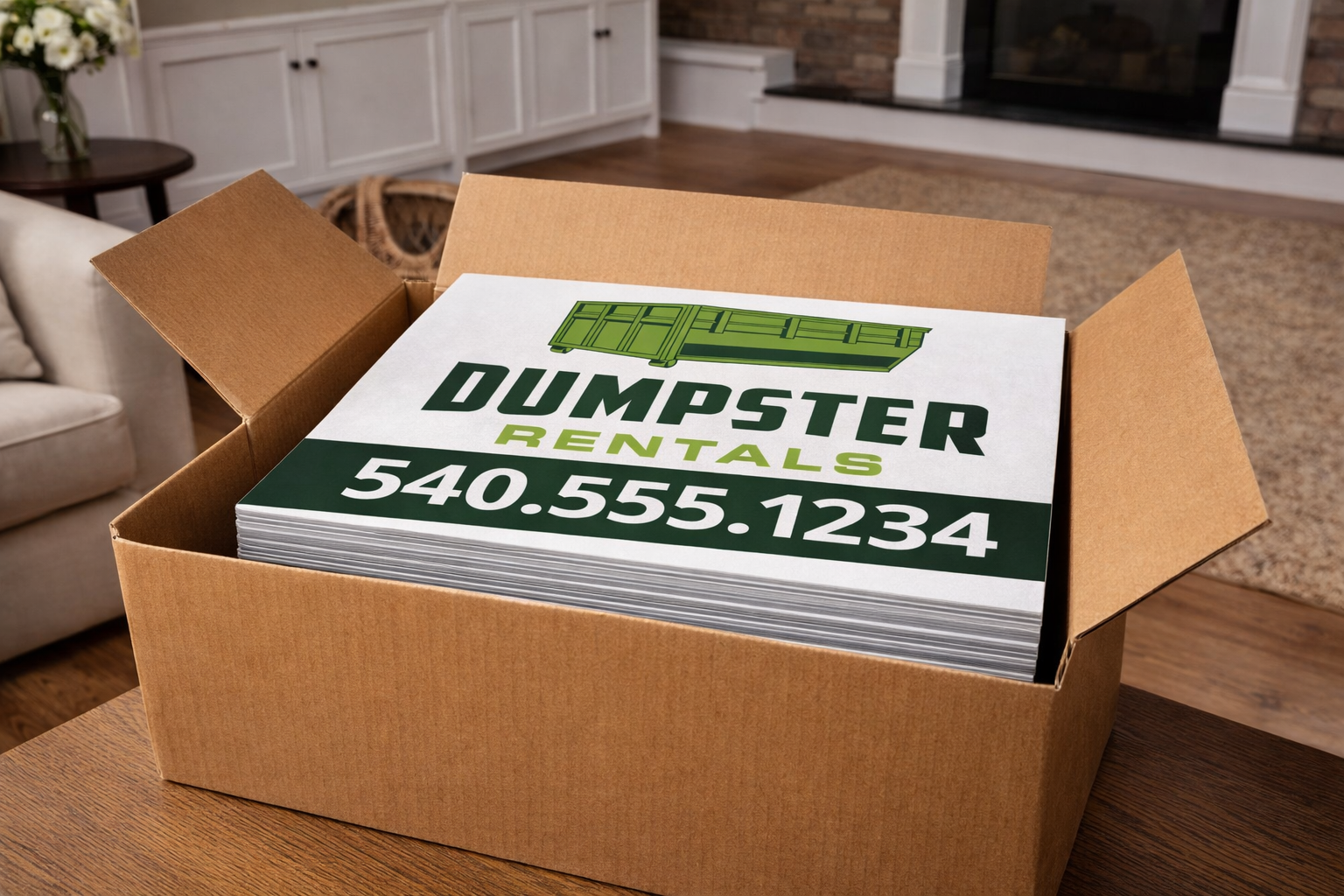 Box of dumpster rental signs with contact information in a living room setting.