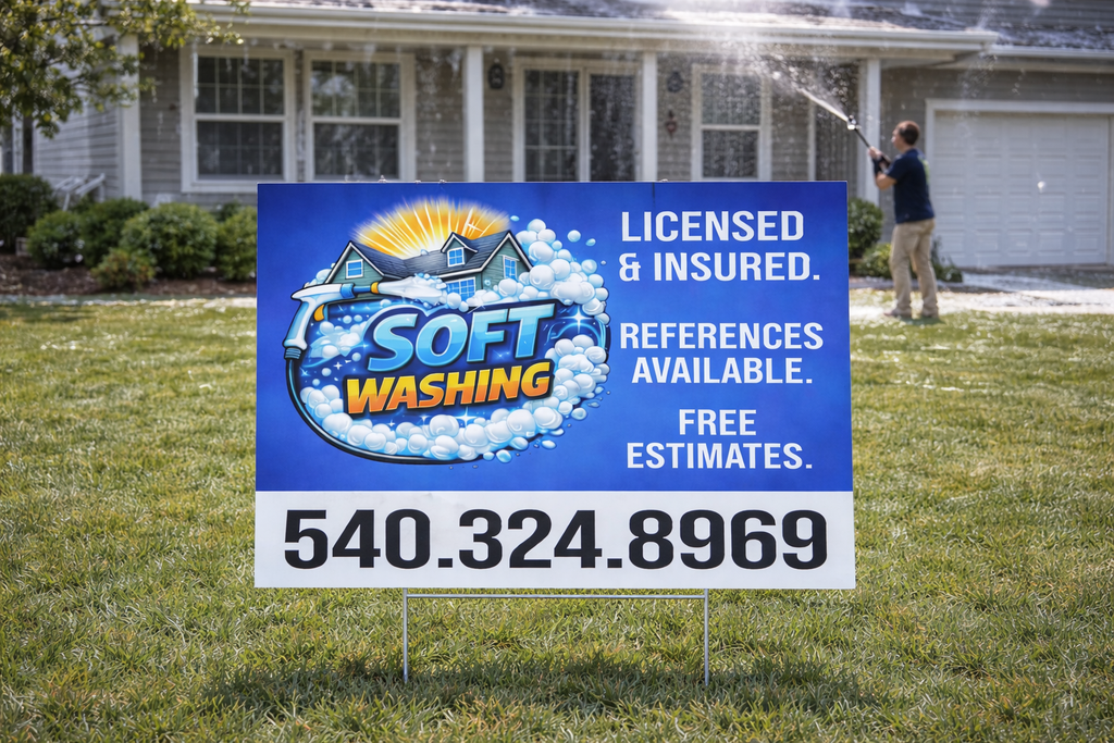 Soft washing service sign in front of a house with a person using a pressure washer.